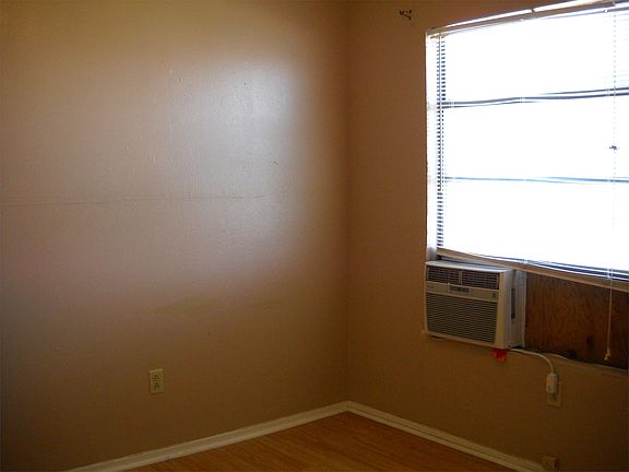 Bedroom 2 has a window A/C unit.