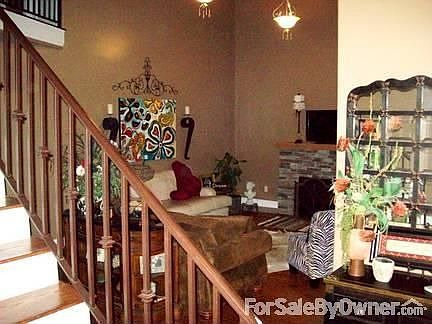 Living Room featuring stone fireplace