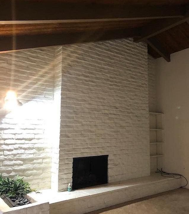 Living Room with raised fireplace and high Cathedral ceiling throughout unit.