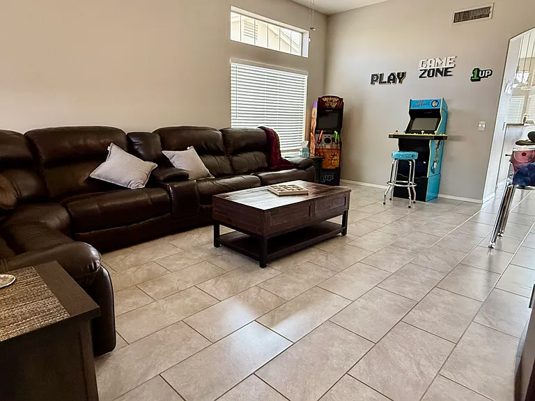 Extra large living space with lots of natural light. Photo is taken from the front door with view through to kitchen and dining room.