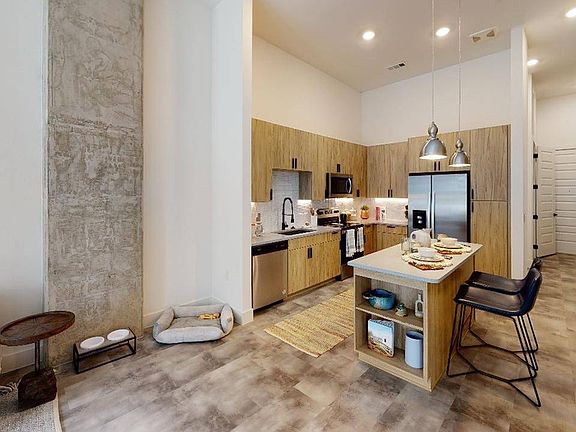 Open layouts abound at Modera Washington, and some home features concrete accents and elevated ceilings.
