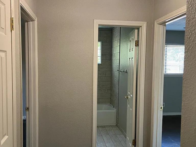 Guest bath located between 1st and 2nd bedrooms. 2 closets in hallway- 1 coat closet and 1 storage closet with shelving
