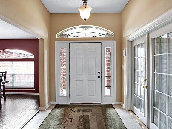 Tiled entry with windows that allow natural light to enter the home