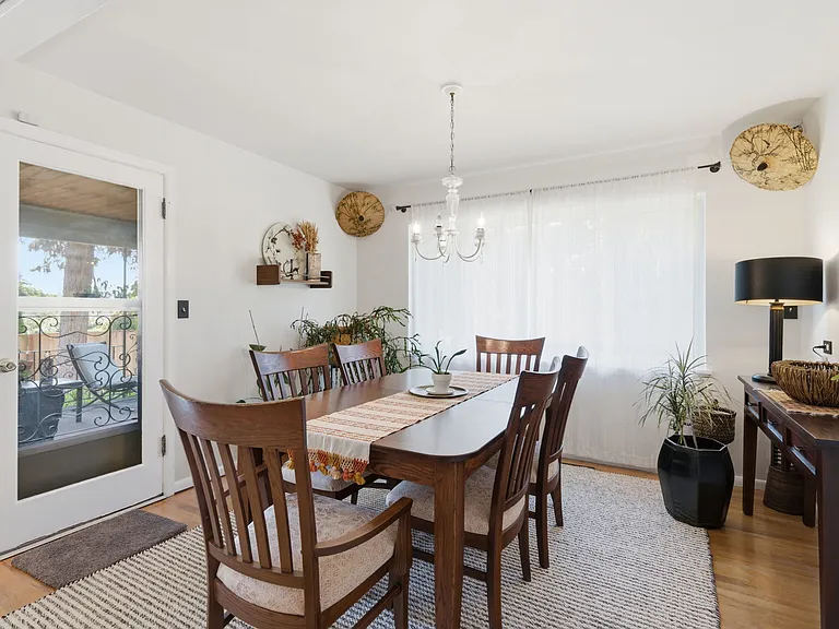 Sunlit dining room with access to covered porch
