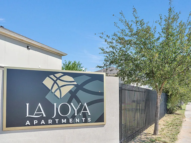 Monument sign for La Joya Apartments, prominently displaying the logo in Laredo, Texas
