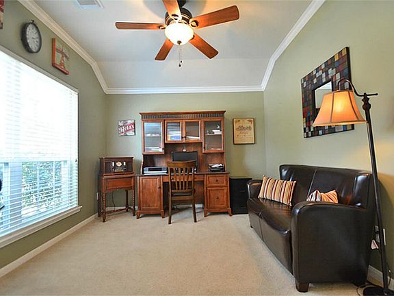 French Glass Panel Door Opens to your Dramatic Study with Custom Ceiling Fan with Light Fixtures, Crown Molding, Custom Two Tone Interior Paint and more!