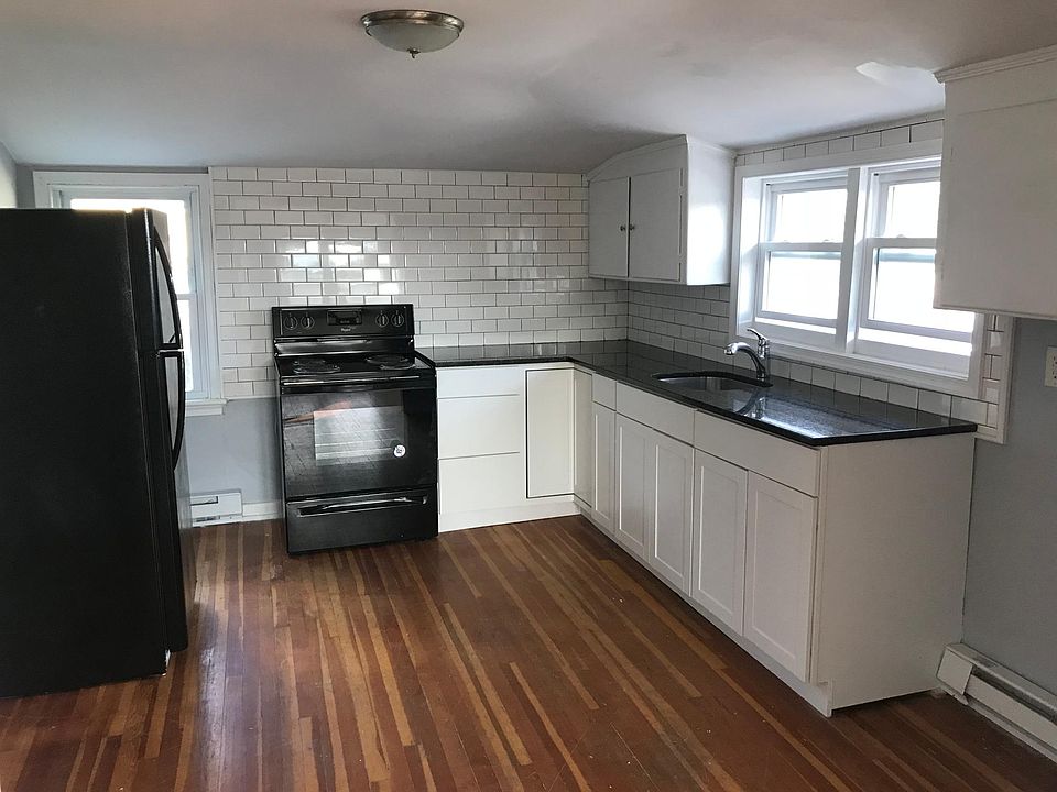 Renovated Kitchen w/ brand new refrigerator and stove. New cabinets, granite countertops and subway tile backsplash