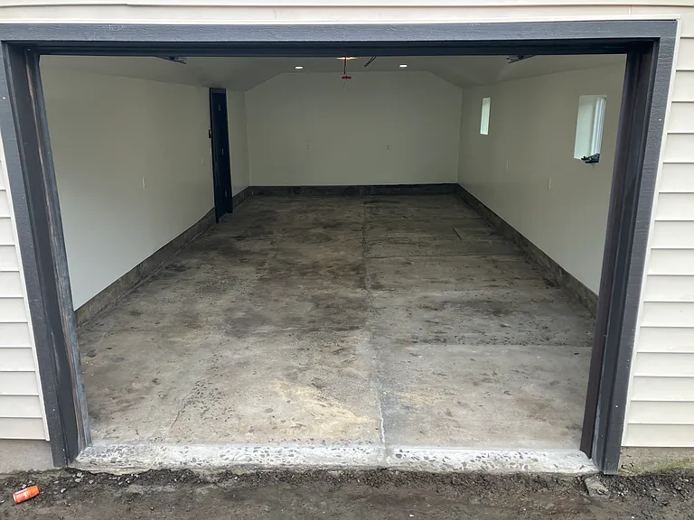 400sqft detached garage is insulated with finished drywall walls and concrete floor.