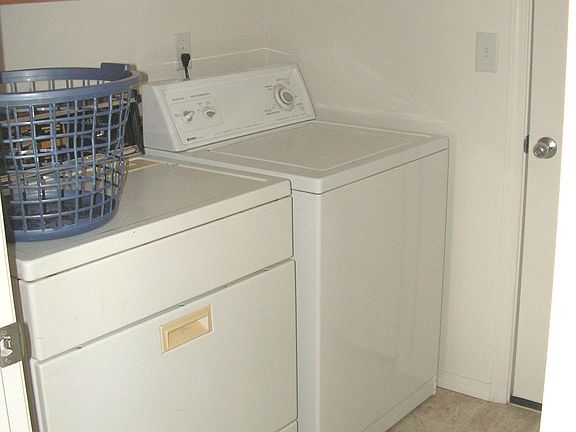 utility room with doors connecting to kitchen and garage
