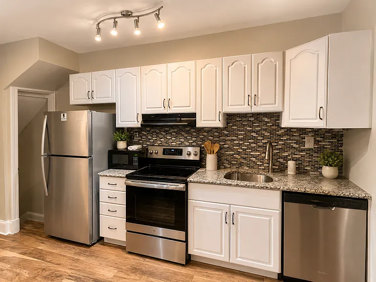 Kitchen with granite countertops and stainless steel appliances.