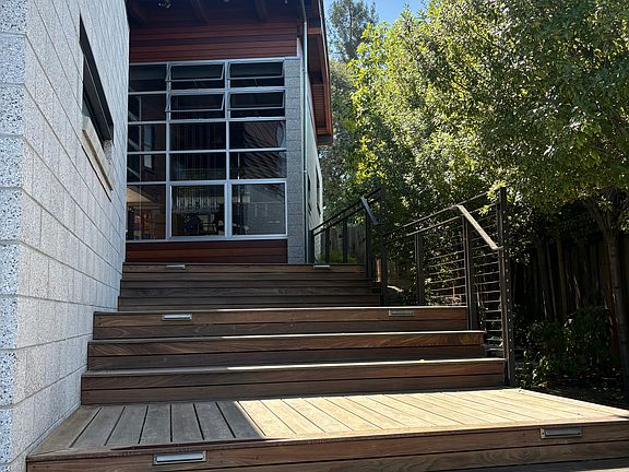 Wood stairs continue on to the front door