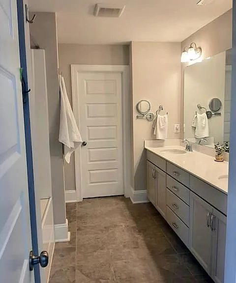 Master bathroom with walk-in closet and two linen closets.