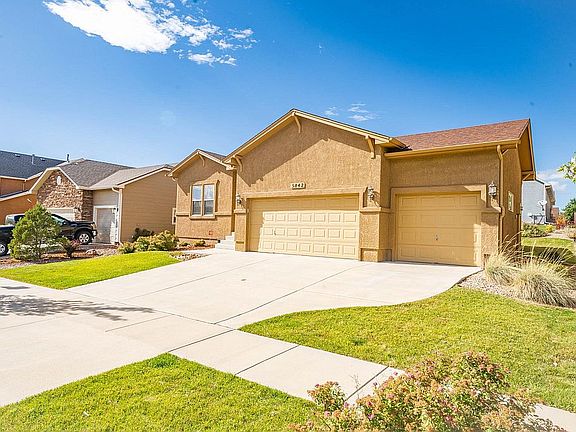 Front of house - steps to the left of the driveway into the house - 3 car garage on right - one main-floor BR on left