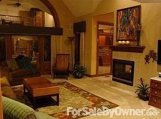 Great Room : 3-side gas fireplace. Woodwork detail. Designer window treatments stay.