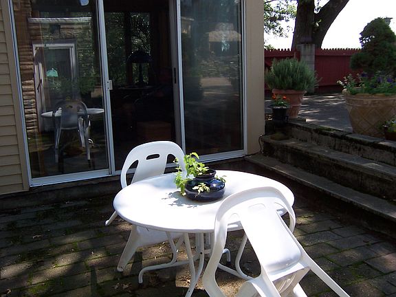 breakfast table off sunroom with steps to backyard