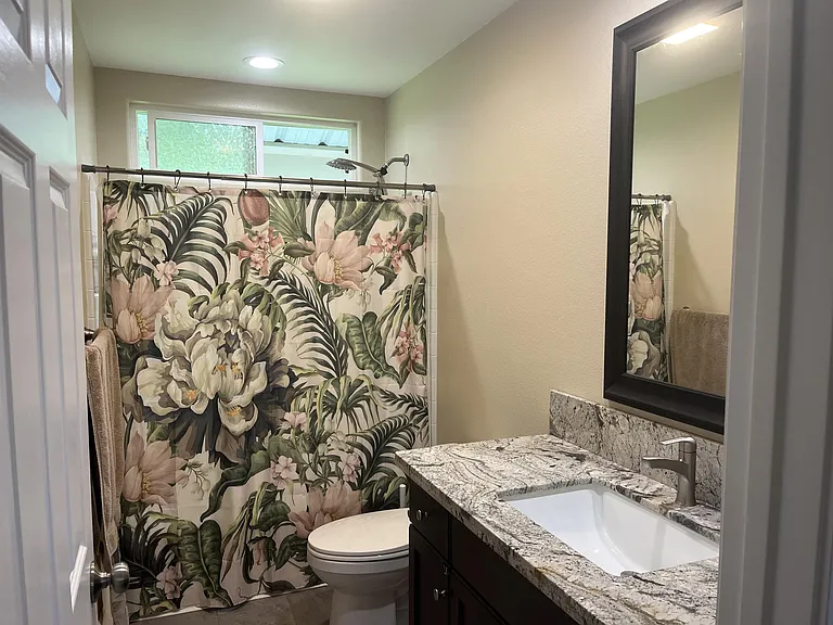 Shared guest bathroom with bathtub and shower