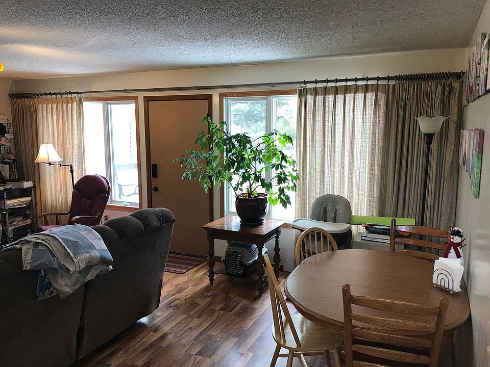 Large living room with big windows and door out to the deck and backyard.