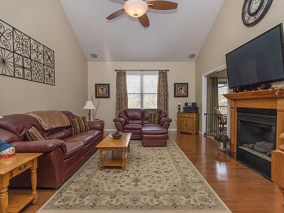 The living room features vaulted ceilings, surround sound built-in speakers and a gas fireplace.