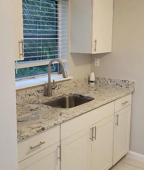 Kitchen sink side with granite counter, stainless sink and window over sink!