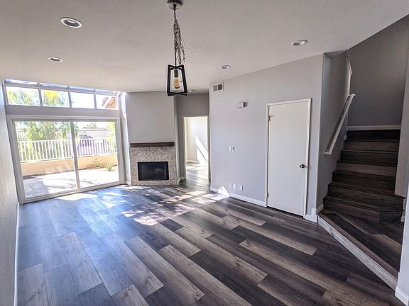 Great room with LED can lighting. Dining light fixture can be hung from a hook and centered on your table. Open door is first floor bedroom. Closed door is storage closet.