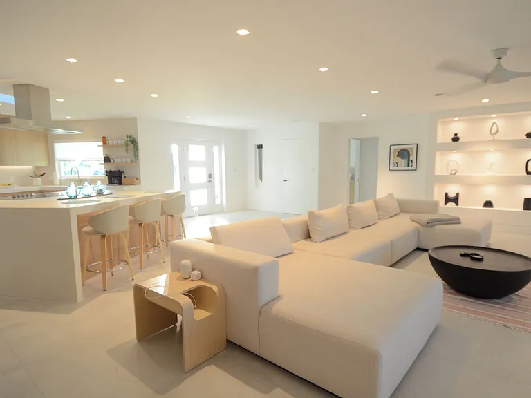 Open space for entertaining and relaxing - sectional looks out onto the pool and inlet