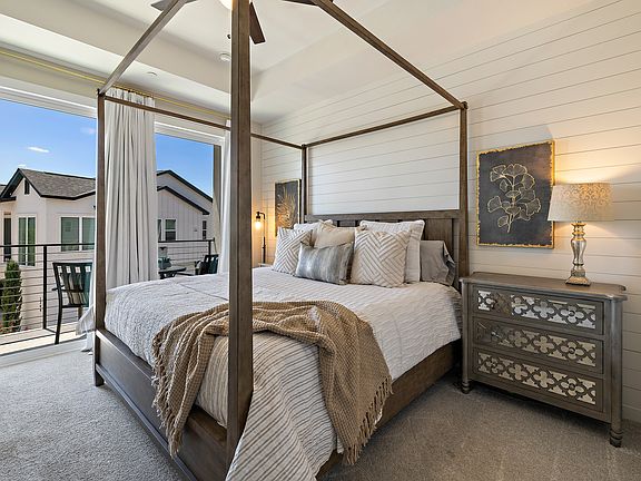 The primary bedroom is on the second level of the home and has a lovely view and balcony.