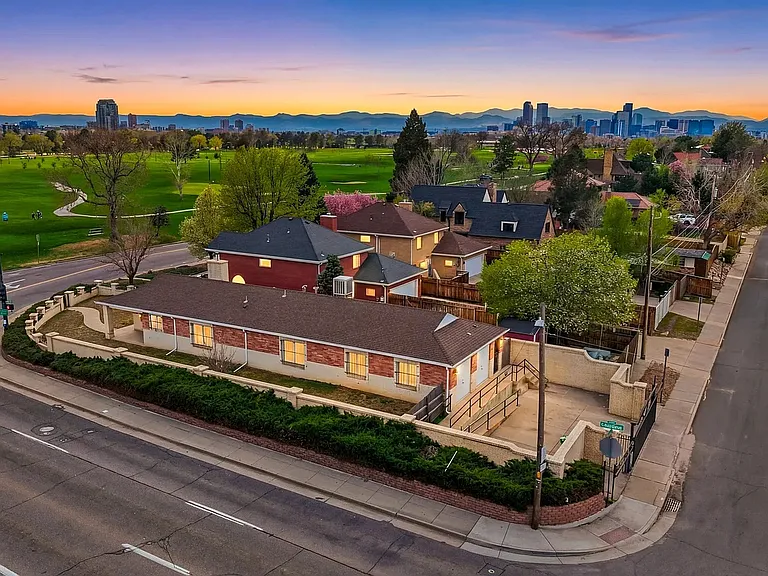 Drone view showing city park golf course & downtown denver in the distance.