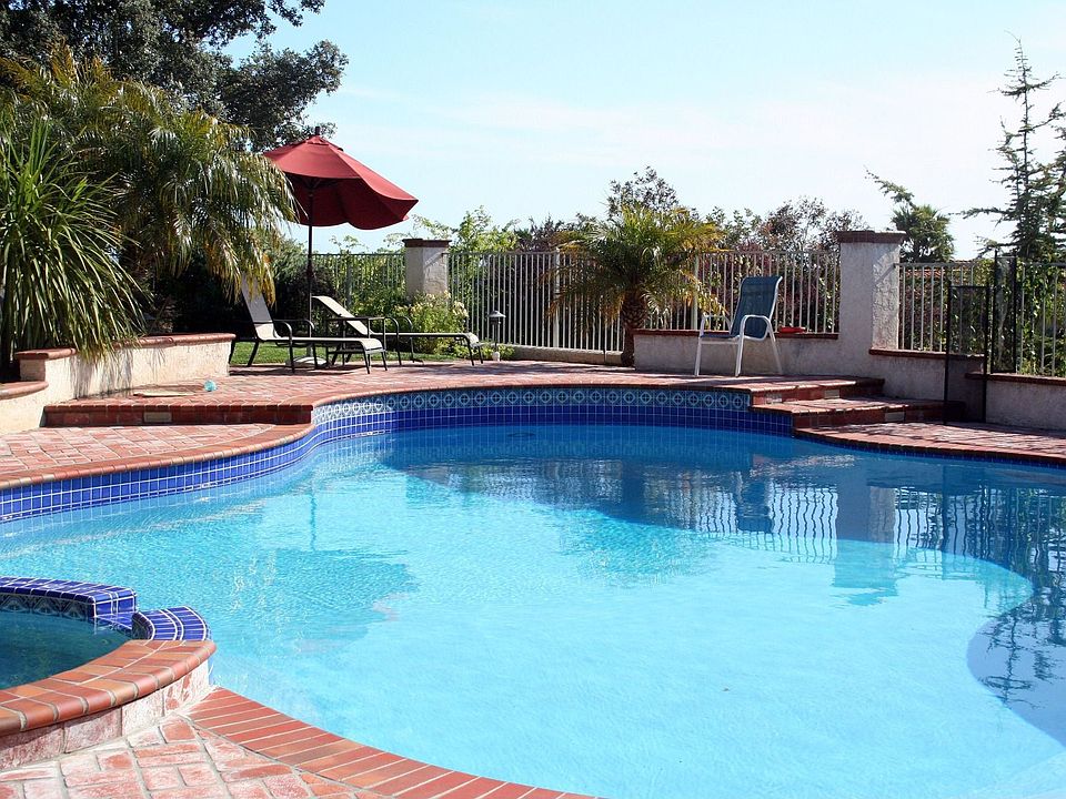 pool and jacuzzi in backyard