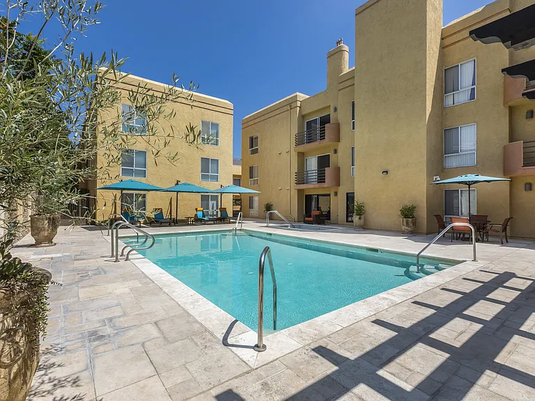Apartments in Burbank, CA - Pool and Patio with Lounge Chairs, Tables and Umbrellas