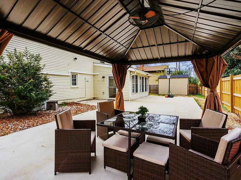 The sunroom opens up to a back patio with gazebo, basketball hoop, swings, barbeque grill and above ground pool.