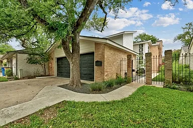 Townhome with 2 car garage, driveway and private fended in landscaped yard.