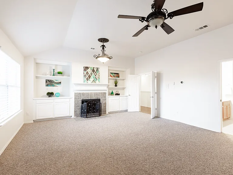 Primary bedroom upstairs with fireplace and sitting area