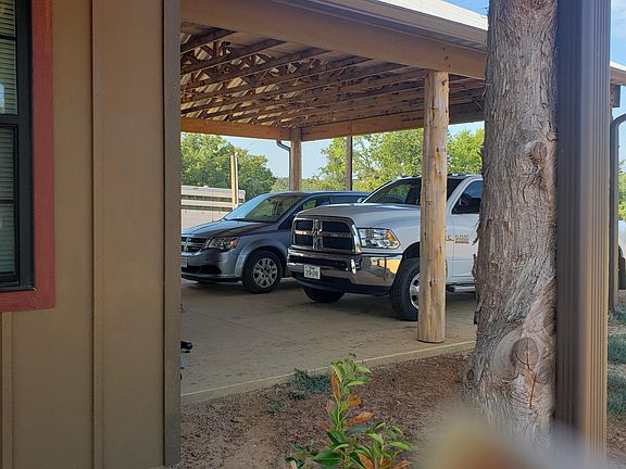 Attached carport. Door leads into utility.