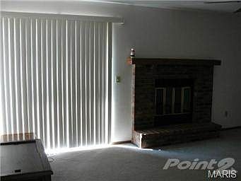 Great room with fireplace and sliding door to deck.