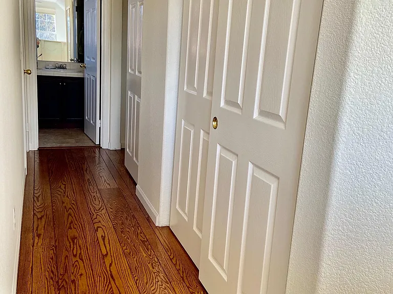 Two huge closets in upstairs hallway in Primary Suite. Primary bath at end of hallway.