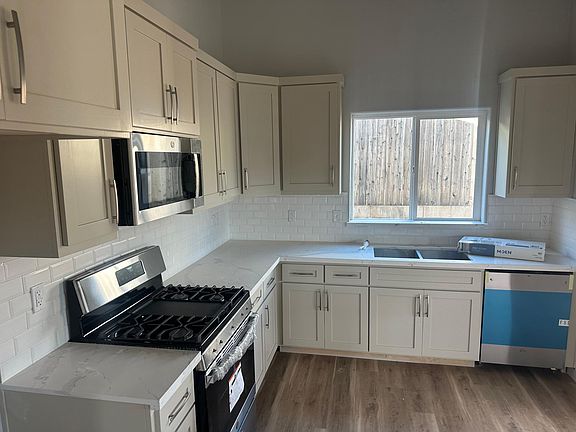 Kitchen pic . Quartz countertops , stainless steel appliances . Brand new everywhere