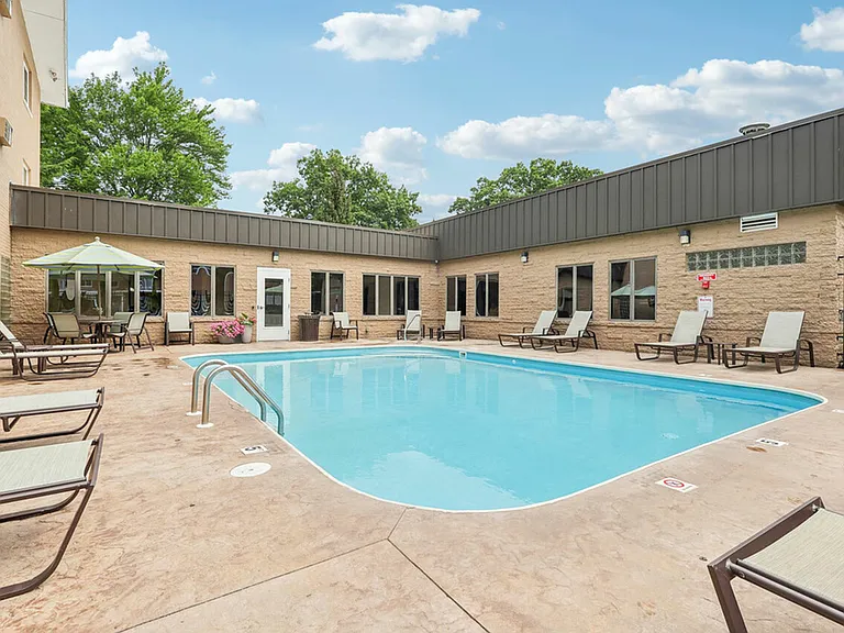 Cool off and relax by the outdoor pool at University Oaks Apartments near Kent State University.