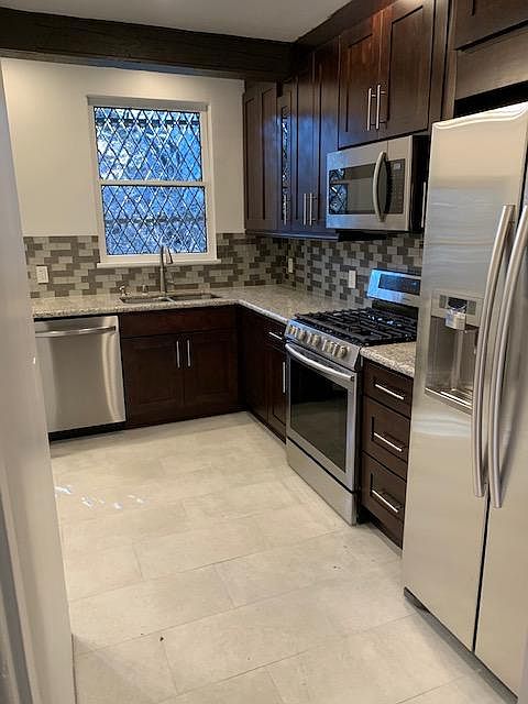 Totally remodeled kitchens a few years ago. Large refrigerator with pouring station for water and ice. Stainless steel stove and stainless steel microwave. When you were at your kitchen sink, all you see is nature through beautiful leaded windows! Note th