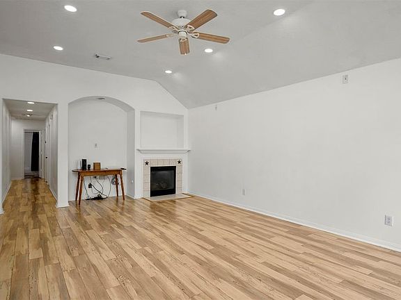 Family room - wood laminate, recessed can lighting, and fireplace create a warm family environment. Includes wiring for Surround Sound.