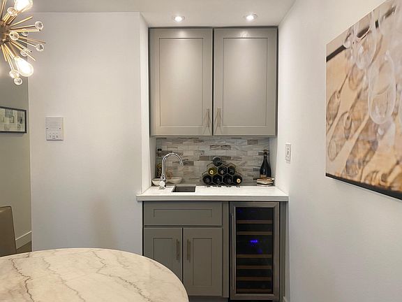Functional wet bar with dual zone undercounter wine refrigerator...it's happy hour!