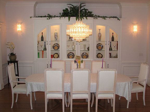Banquet sized dining room with built-in buffet and etched glass divider.