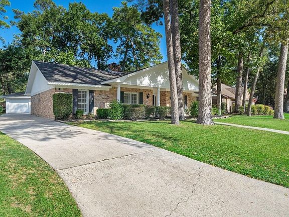 Nice side angle of the beautiful trees that are a hallmark of this well established neighborhood. Driveway leads to a detached two car garage.
