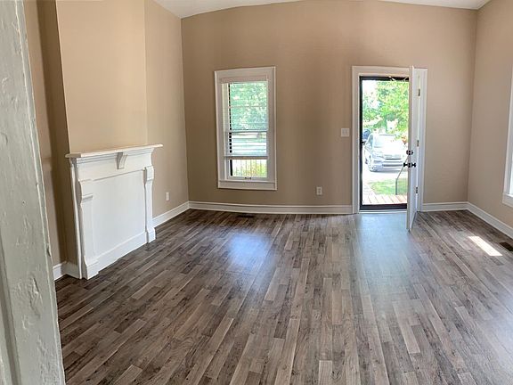 Luxury, easy-to-care-for hard LVP flooring. Huge living room with 10 foot ceilings, charming mantle over historic fireplace. Neutral colors so you can add your own vibe. 2 inch PVC blinds in all rooms on all windows.