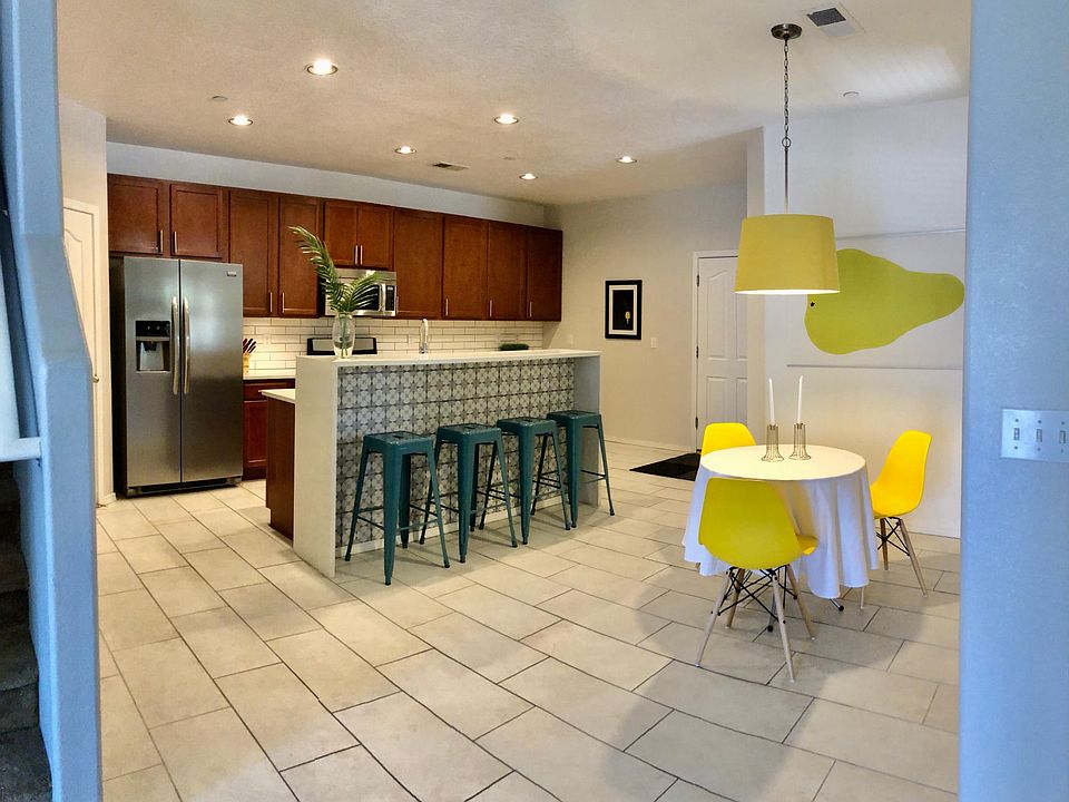 Kitchen with custom tile work, marble-like countertops