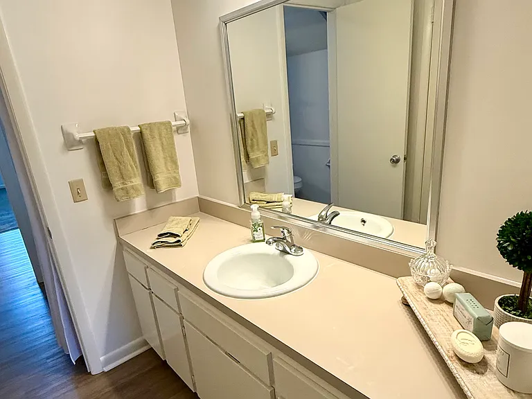 These bedrooms have a Jack and Jill bathroom between them. The vanities are extraordinarily long with lots of cabinetry and large closets. As you can see this is the vanity side of one of the bedrooms. It's has great lighting and a newly framed mirror.