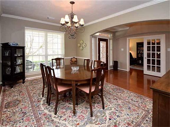 To the right of the foyer is a generously sized dining room with crown molding and chair rail.