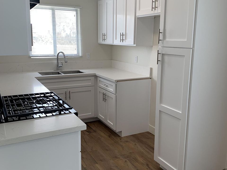 Kitchen with new stove, counter tops, sink and cabinets.