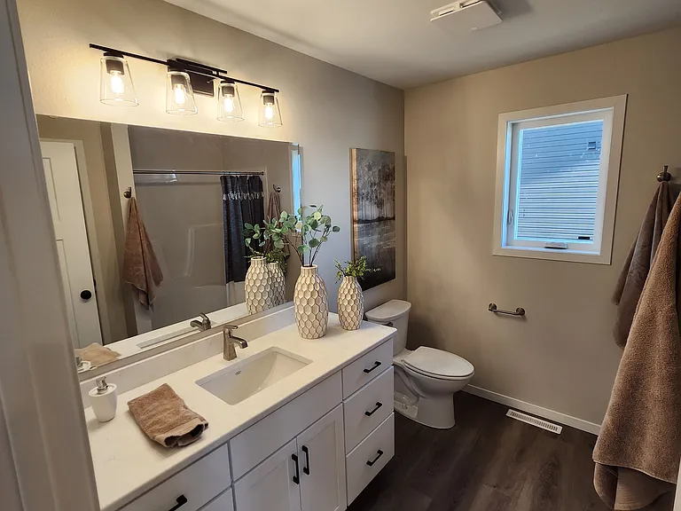 Primary bathroom. (Pictures are of another unit with similar finishes and features.)