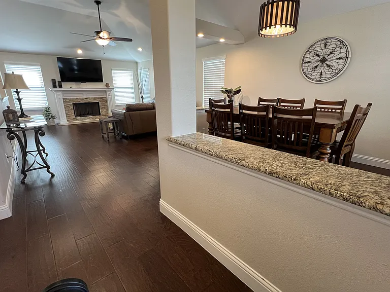 Open-concept living spaces with hardwood flooring and soaring ceilings throughout.