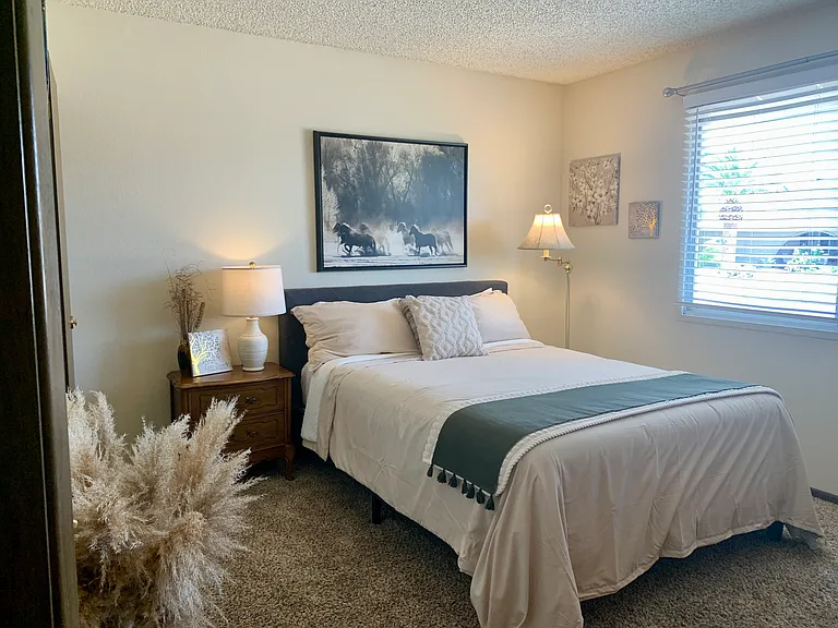 Guest room with queen bed and desk.